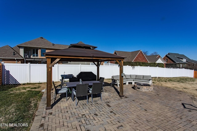 view of patio featuring a gazebo and a fire pit