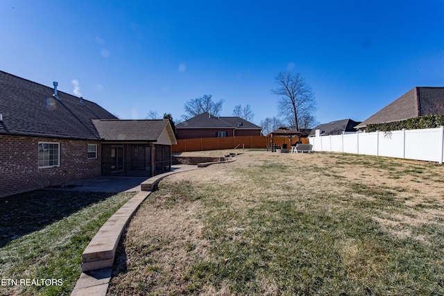 view of yard featuring a gazebo and a sunroom