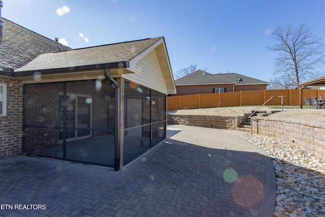 back of house featuring a sunroom and a patio