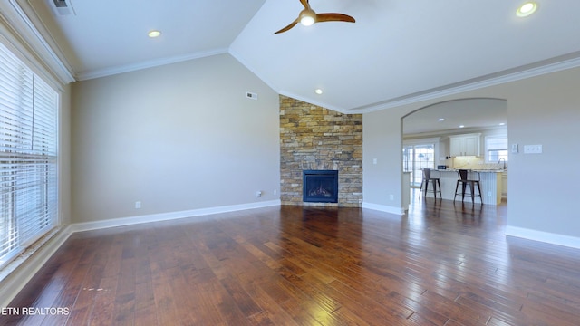 unfurnished living room featuring a fireplace, ornamental molding, and vaulted ceiling