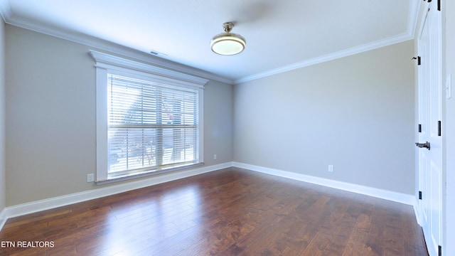 spare room featuring crown molding and dark hardwood / wood-style floors