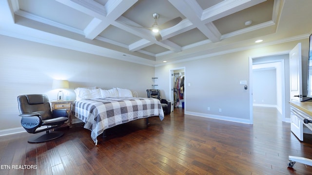 bedroom featuring ceiling fan, a walk in closet, beam ceiling, and coffered ceiling