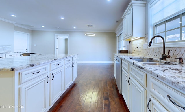 kitchen with light stone counters, sink, decorative backsplash, and dark hardwood / wood-style flooring