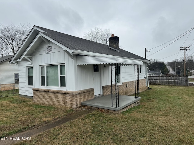 back of house with a lawn