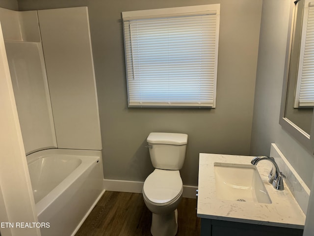 bathroom featuring hardwood / wood-style flooring, toilet, and vanity