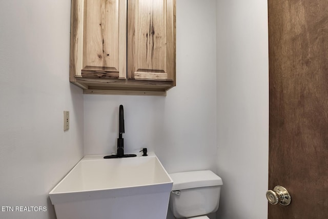 bathroom with sink and toilet