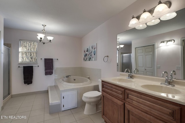 bathroom featuring a notable chandelier, toilet, tiled tub, tile patterned floors, and vanity