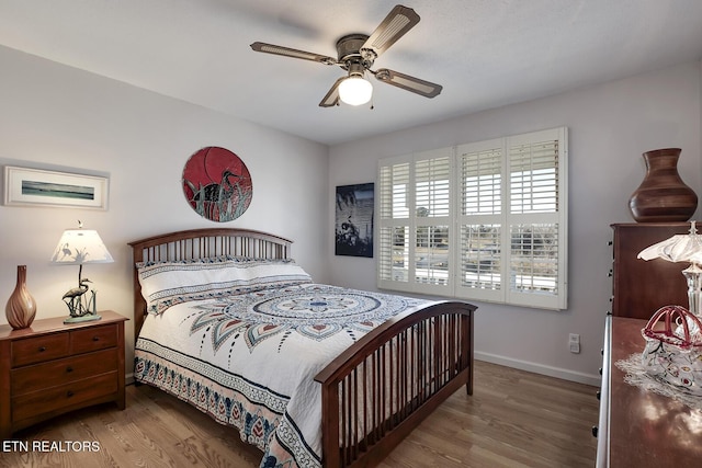 bedroom with ceiling fan and hardwood / wood-style floors