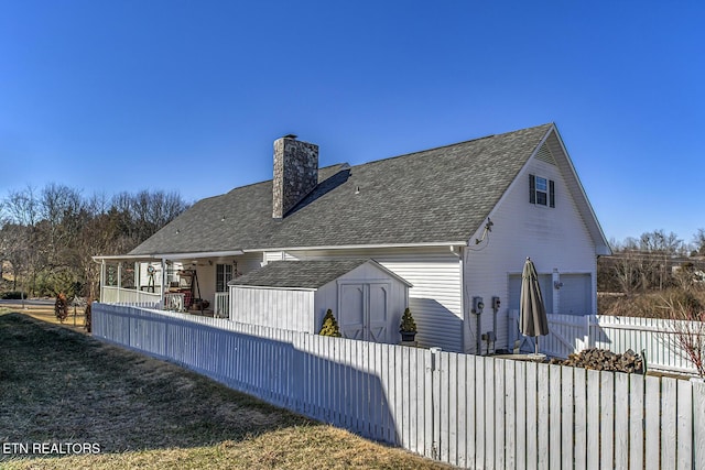 back of property featuring a shed