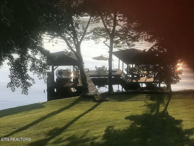 view of yard featuring a water view and a dock