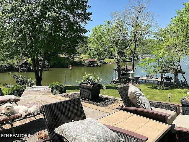 view of patio / terrace with a water view and a boat dock