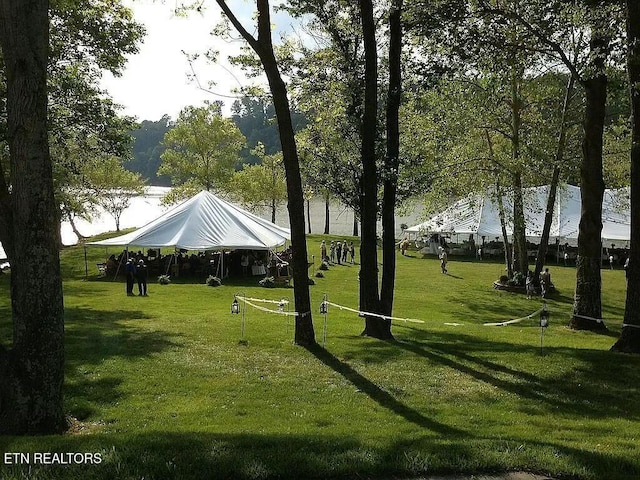 view of community with a lawn and a water view