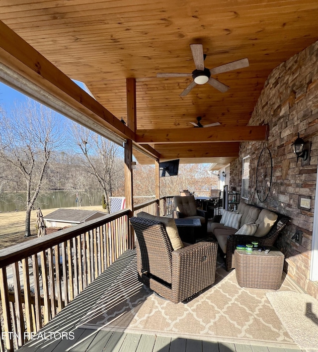 wooden deck featuring ceiling fan and an outdoor living space