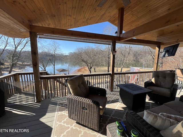 wooden deck featuring a water view and outdoor lounge area