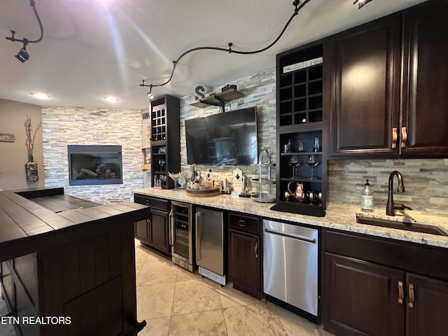 kitchen featuring light tile patterned flooring, refrigerator, sink, decorative backsplash, and dark brown cabinets