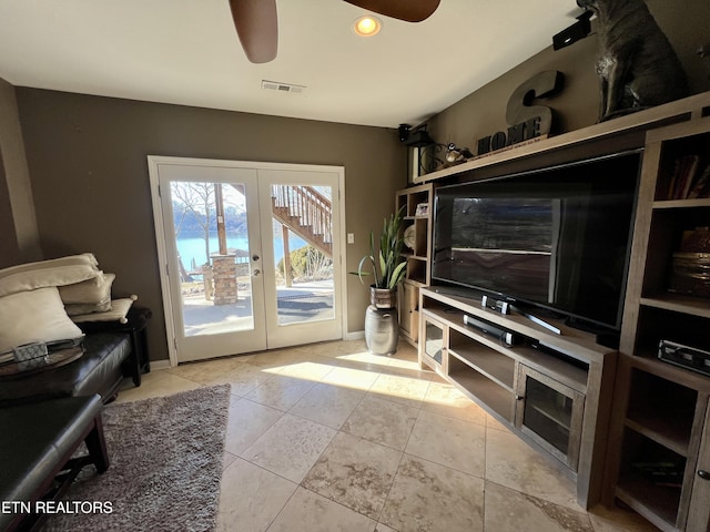 living room featuring french doors, ceiling fan, and light tile patterned flooring