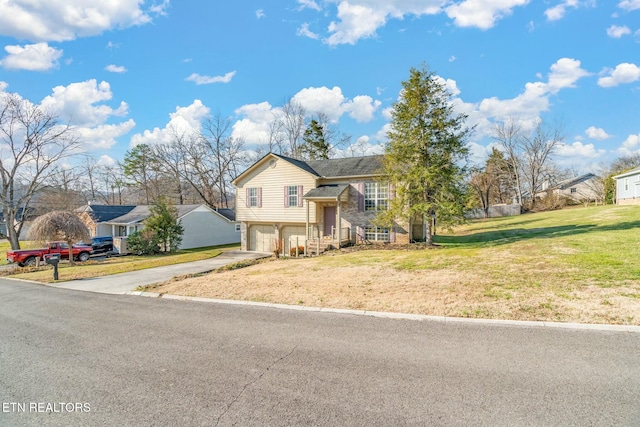 bi-level home with a garage and a front yard