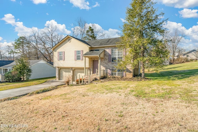 bi-level home featuring a garage and a front lawn