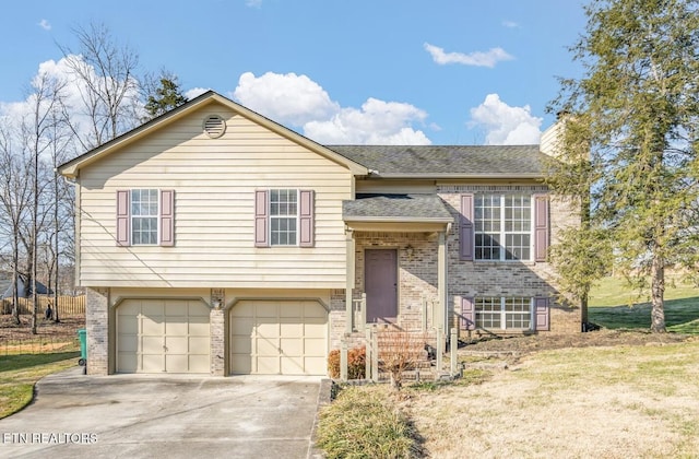 bi-level home with a garage and a front yard