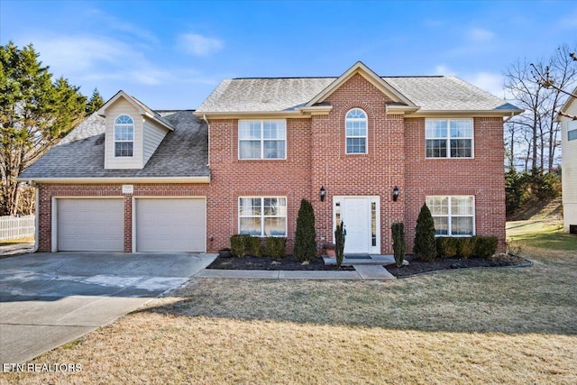 view of front of property featuring a garage and a front lawn