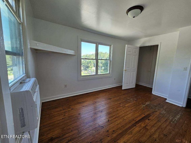 unfurnished bedroom featuring dark hardwood / wood-style flooring