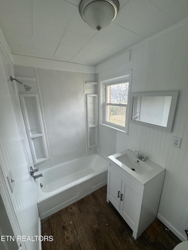 bathroom with hardwood / wood-style flooring, shower / bath combination, and vanity