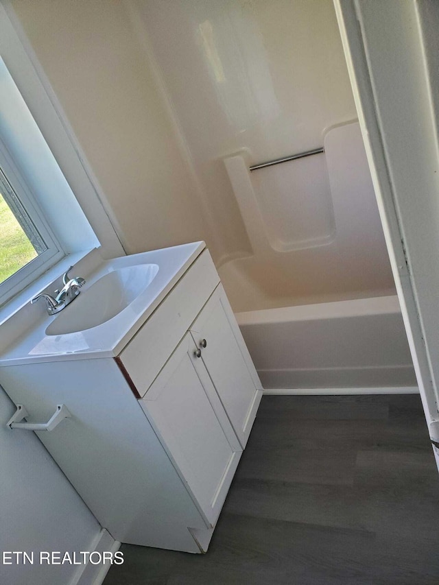 bathroom with vanity and shower / washtub combination