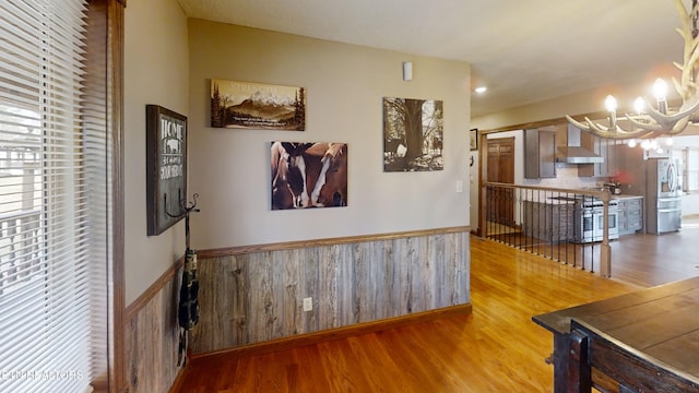 interior space with wood-type flooring and a chandelier