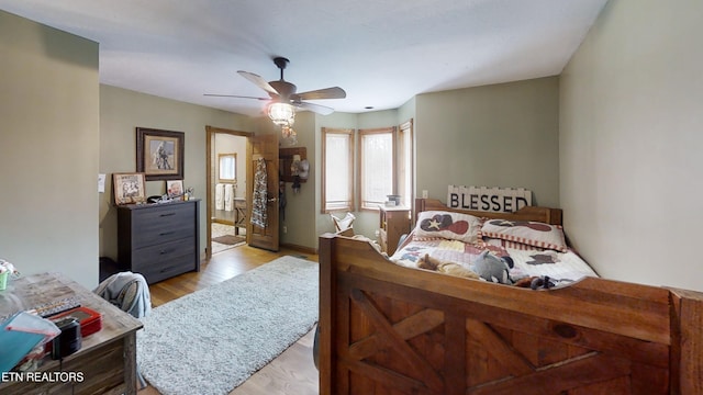 bedroom with ceiling fan and light hardwood / wood-style flooring