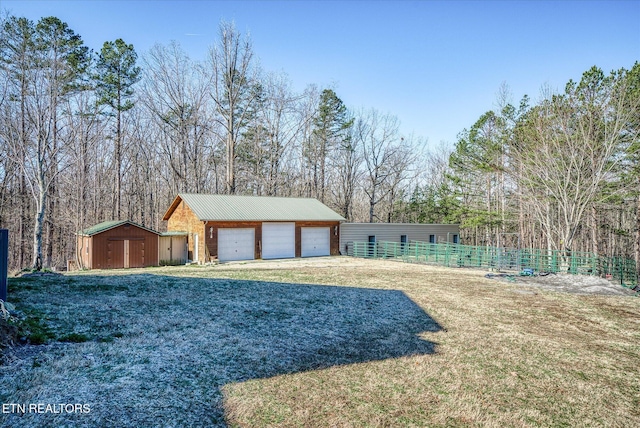 exterior space featuring a garage, a front lawn, and a storage unit