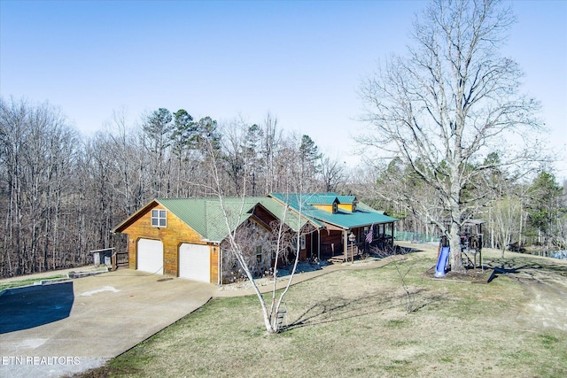 view of front of property with a garage and a front lawn