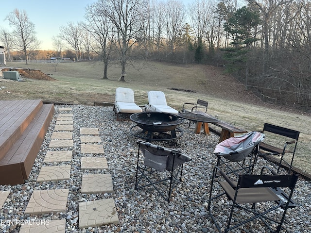 patio terrace at dusk featuring a fire pit