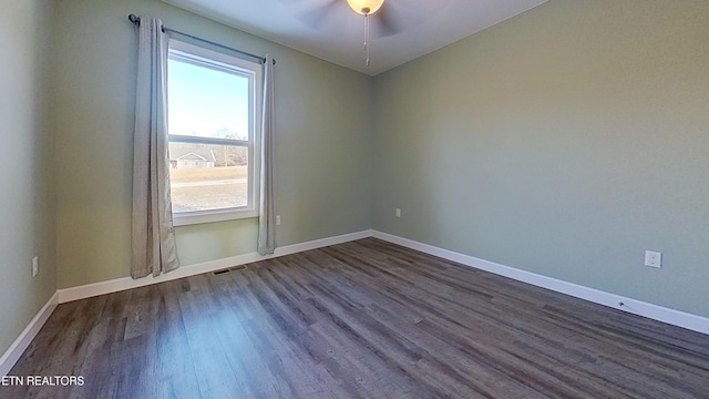 empty room with dark hardwood / wood-style flooring