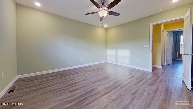 spare room featuring hardwood / wood-style flooring and ceiling fan