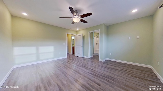 unfurnished bedroom featuring ceiling fan, hardwood / wood-style floors, and ensuite bath