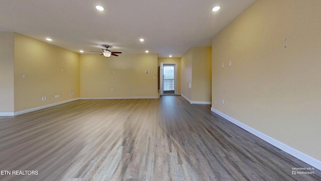 spare room with wood-type flooring and ceiling fan