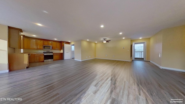 unfurnished living room with ceiling fan and light hardwood / wood-style flooring