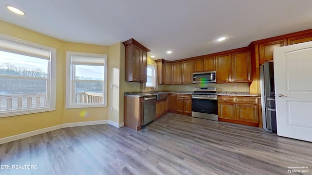 kitchen featuring hardwood / wood-style flooring, stainless steel appliances, and sink