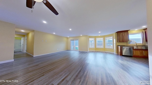 unfurnished living room featuring hardwood / wood-style flooring and ceiling fan