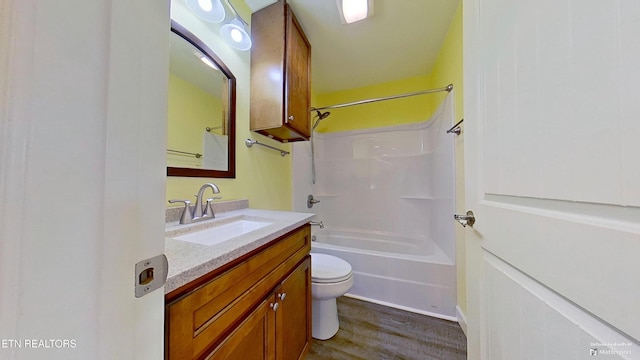 full bathroom featuring shower / tub combination, vanity, wood-type flooring, and toilet