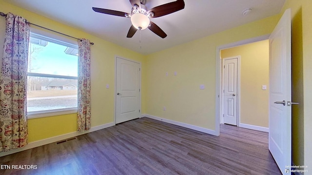 empty room featuring wood-type flooring and ceiling fan