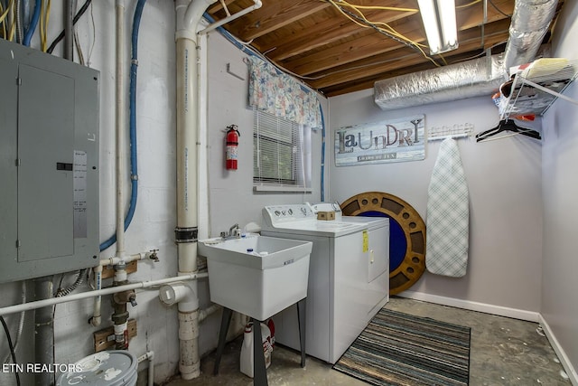 laundry room featuring sink, washing machine and clothes dryer, and electric panel