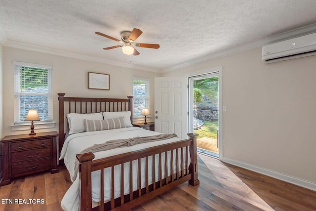 bedroom with ceiling fan, access to exterior, multiple windows, and hardwood / wood-style flooring