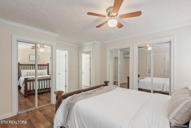 bedroom with ceiling fan, a wall mounted AC, multiple closets, ornamental molding, and dark hardwood / wood-style flooring