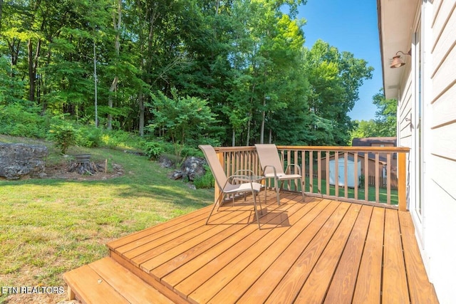 wooden deck featuring a yard