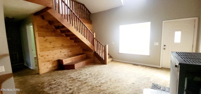 stairs featuring carpet flooring