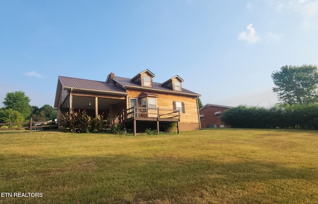 back of house with a wooden deck and a lawn