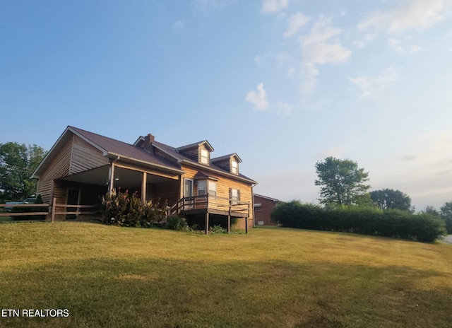 rear view of house featuring a yard