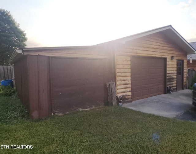 garage featuring a lawn