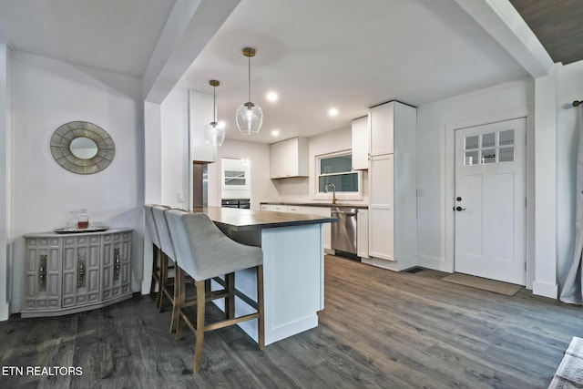 kitchen with white cabinetry, kitchen peninsula, dishwasher, pendant lighting, and sink